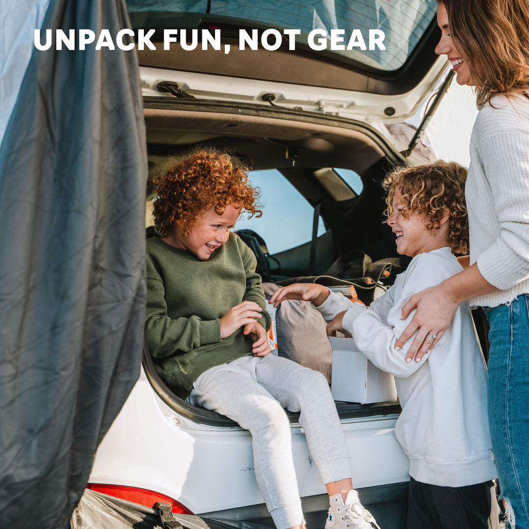 Family siting in the hatch of a vehicle