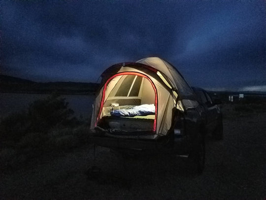Napier outdoors backroadz truck tent grey and red in night time