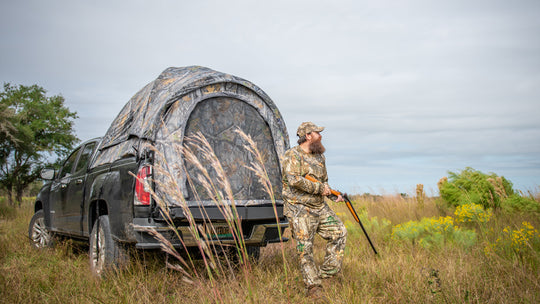 Hunter outside of his camo truck tent