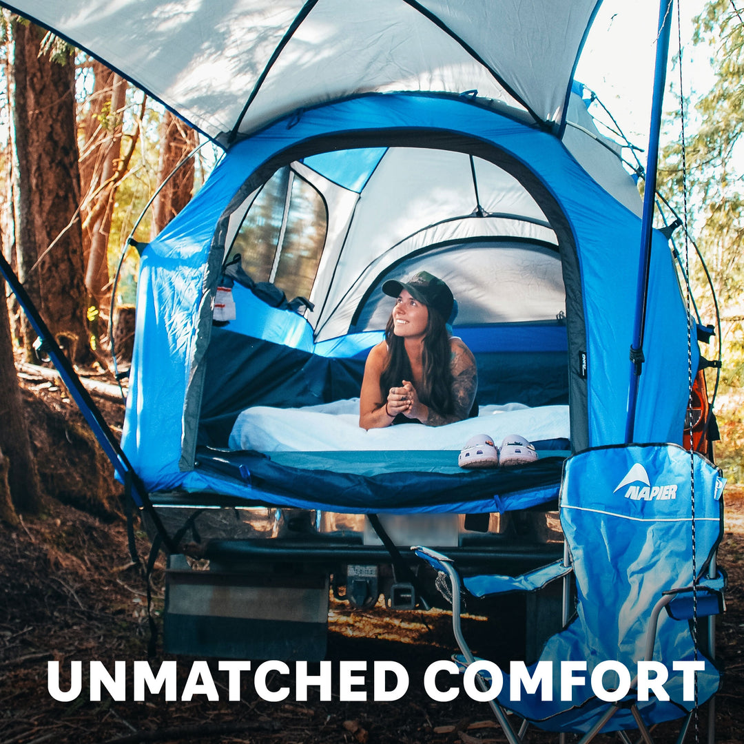 Girl laying down inside of a napier truck tent with awning, unmatched comfort