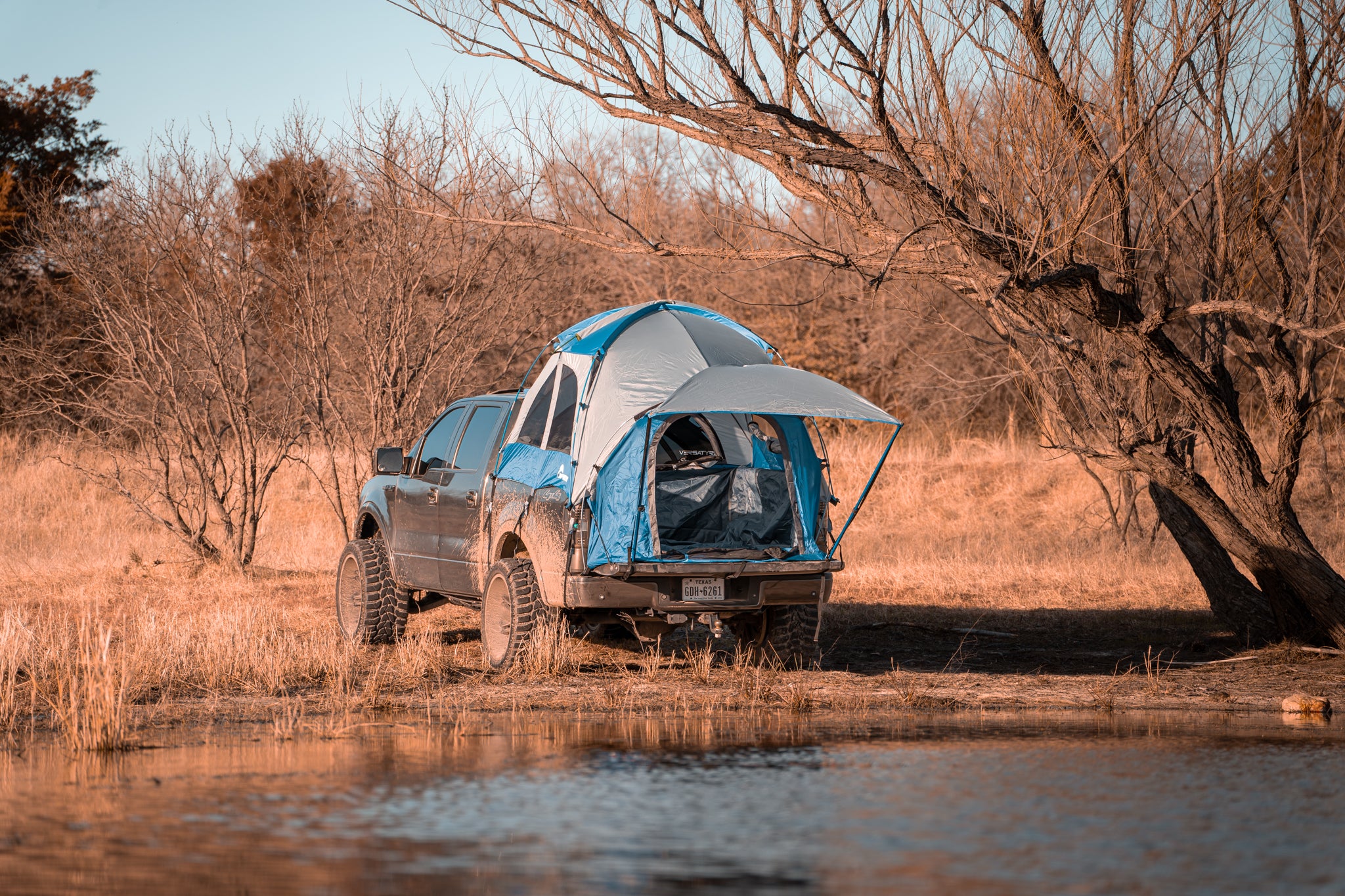 Napier truck tent camping set up on a truck next to the lake