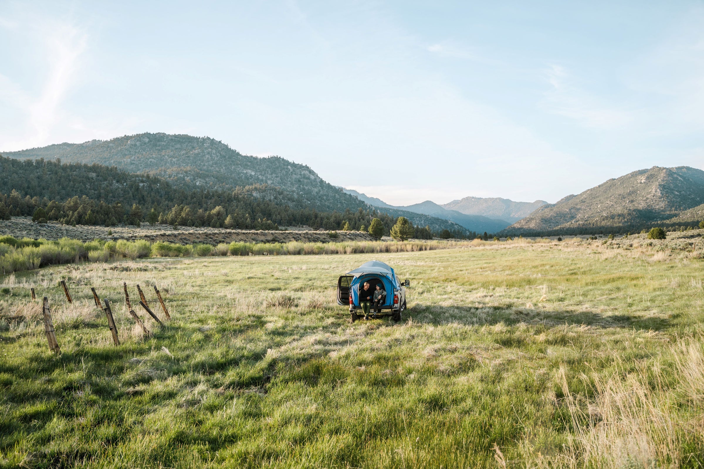 napier truck tent camping and overlanding set up in a field