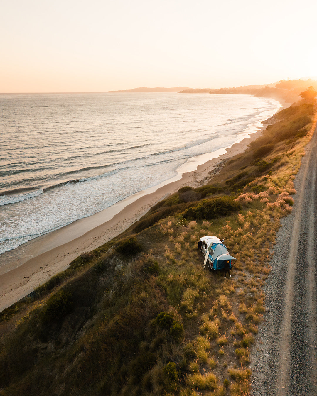 Truck tent overlanding set up on the side of the ocean