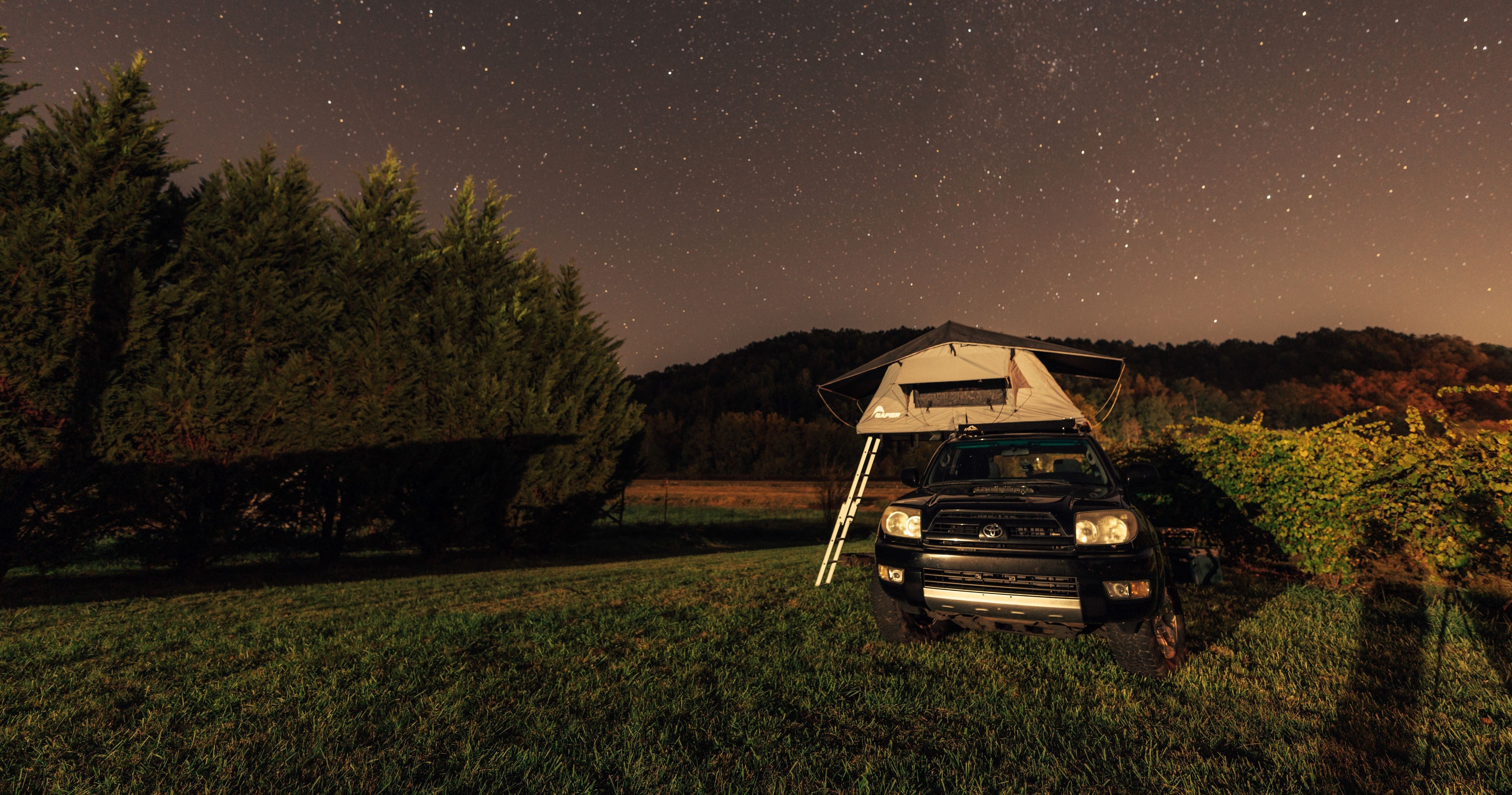 Napier outdoors rooftop tent camping overlanding set up in the forest at night